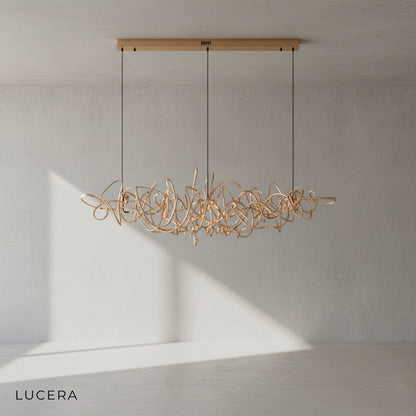 overhead angle of Isabelline rectangle chandelier in gold finish above marble kitchen island