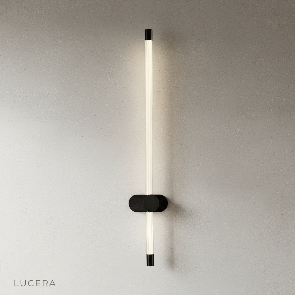 yoke wall lamp angled downward casting focused light on a reading chair