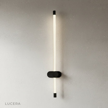 yoke wall lamp angled downward casting focused light on a reading chair