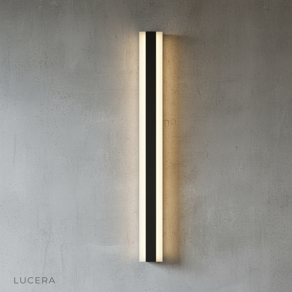 Drambuie sconce mounted on brick wall casting soft glow over outdoor dining table