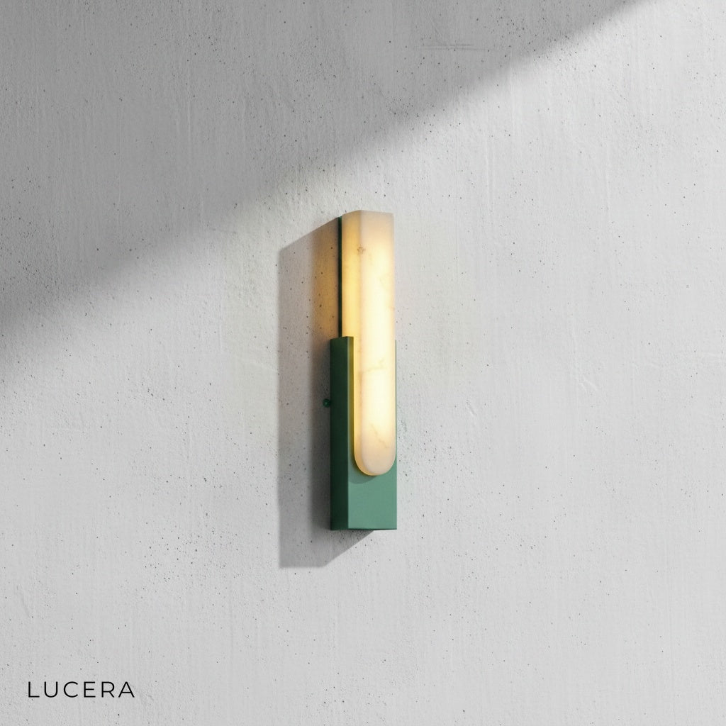 Rumore marble wall lamp casting soft glow in minimalist entryway