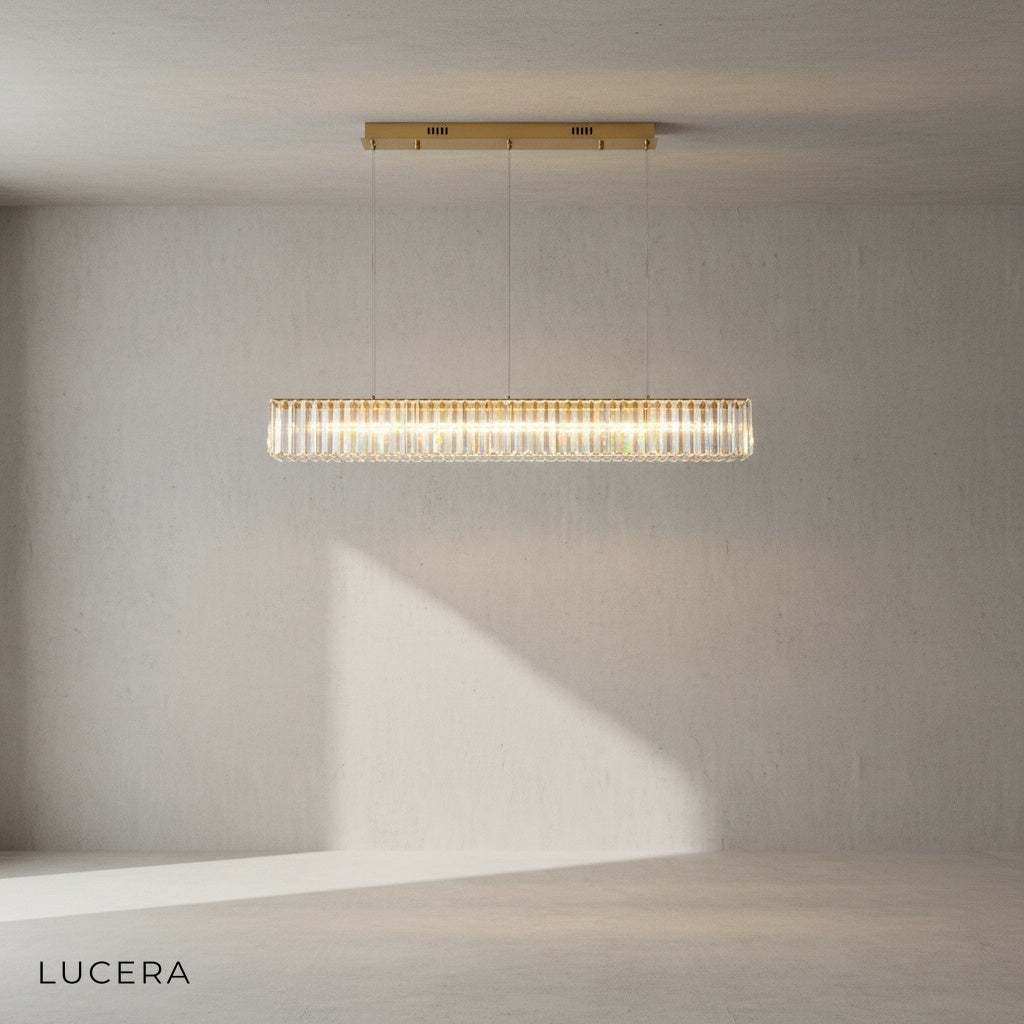 Ivar LED chandelier suspended above a rustic wooden dining table in an open-plan loft