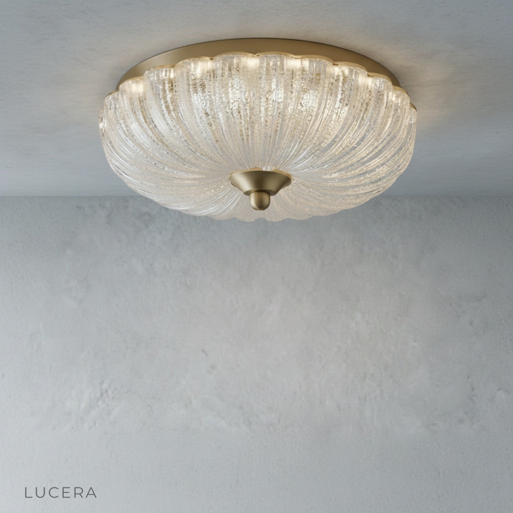 detailed view of glass shade and brass socket on modern ceiling fixture