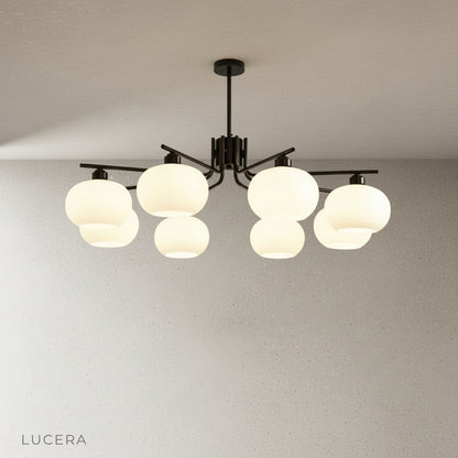 Side-angle studio photo showing the Tempo Chandelier's spherical glass shades and slim metal rods