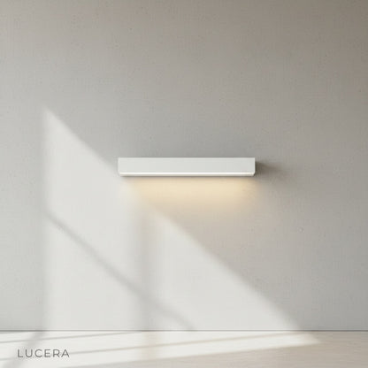 Goccia wall lamp paired with wooden bench on patio, evening warm lighting