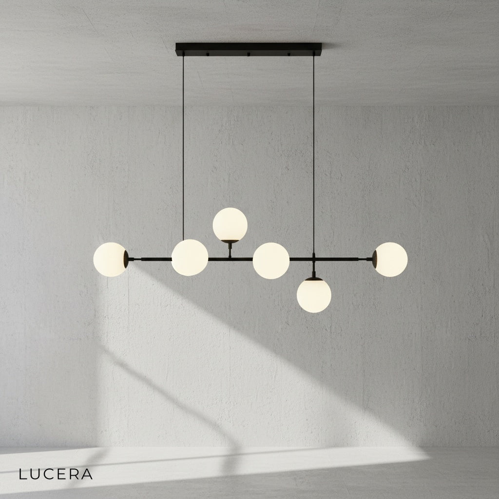smoke glass ball pendant light suspended from black iron frame in contemporary loft