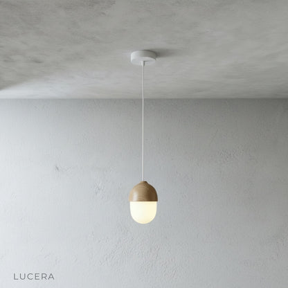 angled studio view of Holly pendant light highlighting its cylindrical wood-look shade