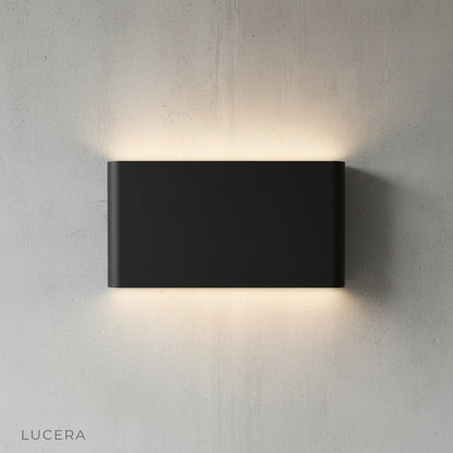 Cadmium wall lamp in hallway with minimalist decor and warm light
