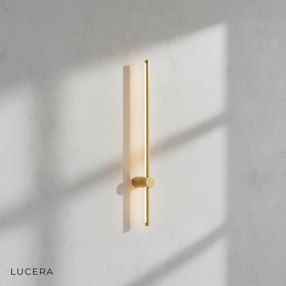 Rinforzando minimalist wall light casting warm glow in bedroom