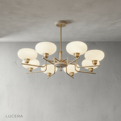 five-head inlet chandelier hanging over a minimalist living room sofa with neutral tones