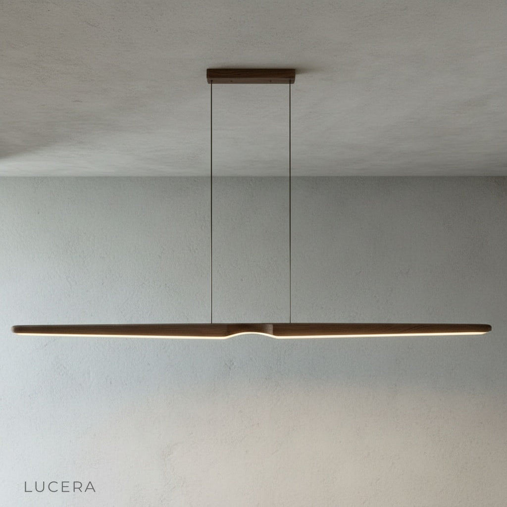 Ember wood pendant light over a rustic dining table with wooden chairs and soft daylight