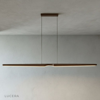 Ember wood pendant light over a rustic dining table with wooden chairs and soft daylight