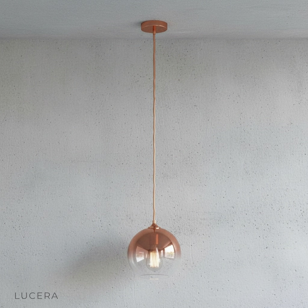 Detail of brass cord and ceiling mount on green gold glass pendant light fixture