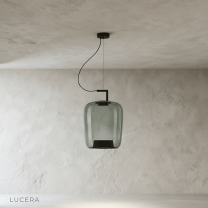 Yardang pendant light metal ceiling mount and cord detail against neutral wall background