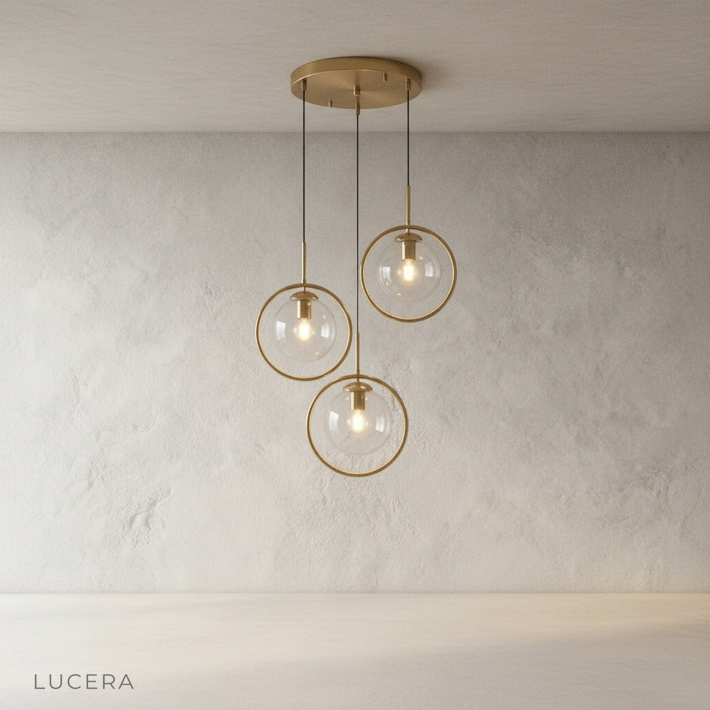 Caelus pendant light clear glass globe reflecting warm light in a minimalist hallway