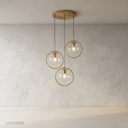 Caelus pendant light clear glass globe reflecting warm light in a minimalist hallway