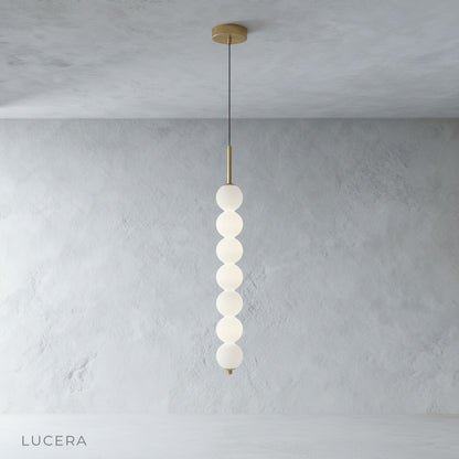 Meridian Pendant Light glass shades casting soft shadows on neutral bedroom wall