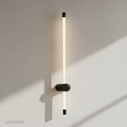 yoke wall lamp glowing at dusk in a cozy living room with sofa and rug
