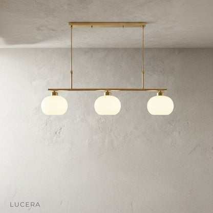 Tempo Chandelier hanging above a rustic wooden table, blending modern metal with natural textures