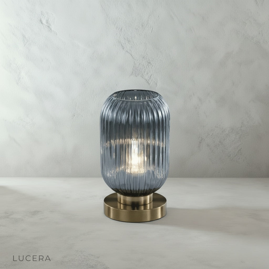 close up of warm light glowing through textured glass cylinder at dusk