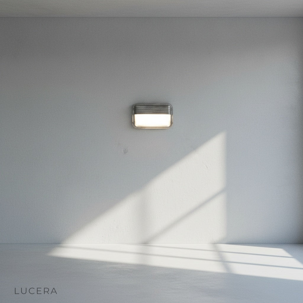 nighttime ambient shot of Acolyte wall light illuminating a patio seating area