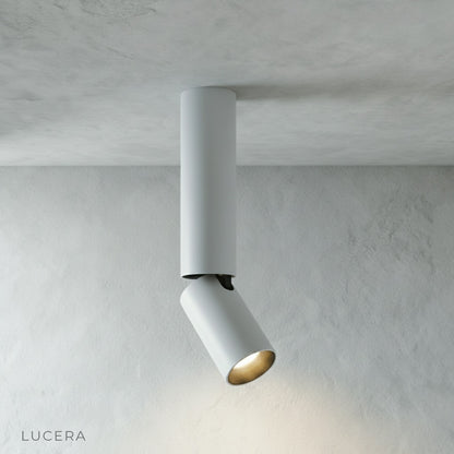 Bewitch ceiling light in dining room setting with warm ambient light casting focused beams on table
