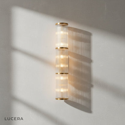 outdoor IP44 rated Trill crystal sconce glowing on covered patio wall