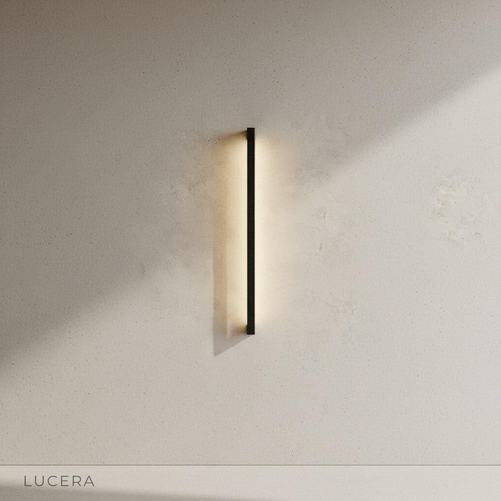 indigo outdoor wall lamp casting soft glow along wooden deck pathway