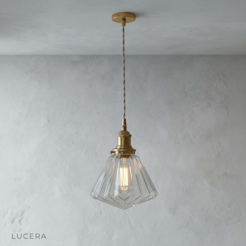 close-up of glass pendant light showing warm LED filament through transparent shade
