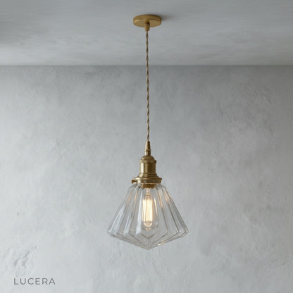 close-up of glass pendant light showing warm LED filament through transparent shade