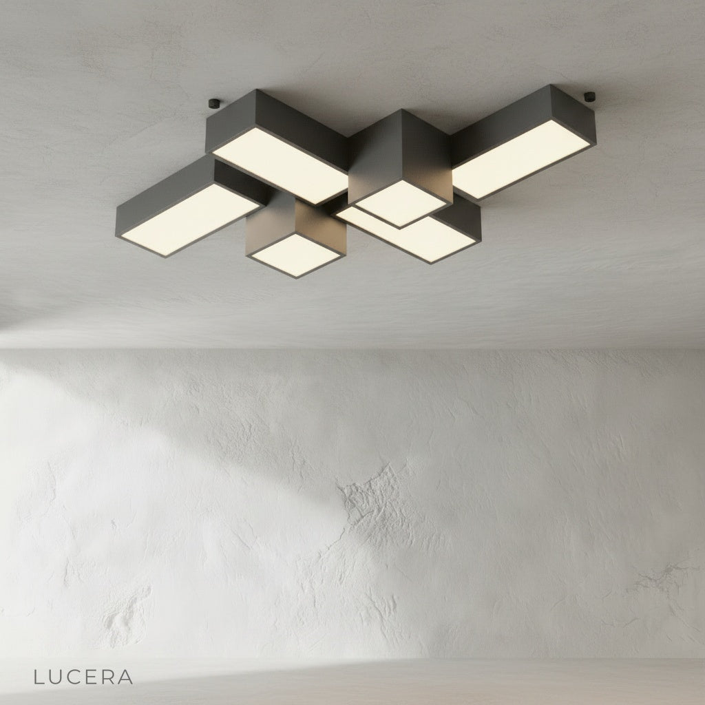 Sculptural black ceiling fixture casting soft light over neutral bedroom