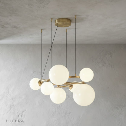 Grenache chandelier over bedside table in cozy bedroom setting