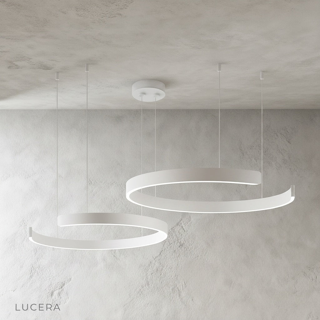 Bedeck chandelier hanging above marble island with soft ambient glow
