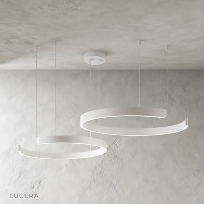 Bedeck chandelier hanging above marble island with soft ambient glow