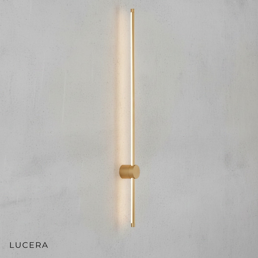 Rinforzando wall lamp in brushed silver finish on textured concrete wall