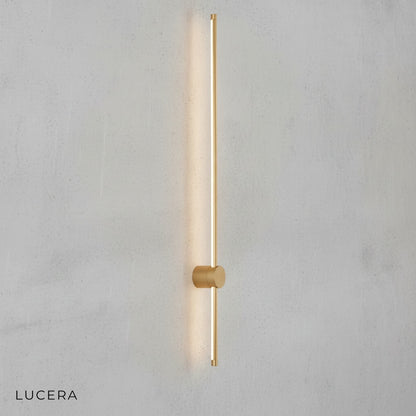 Rinforzando wall lamp in brushed silver finish on textured concrete wall