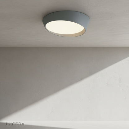 overhead view of alabaster ceiling light with textured acrylic surface and metallic rim