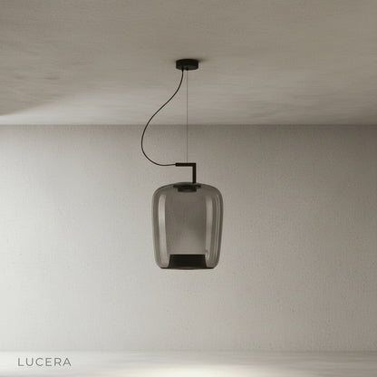 Yardang pendant light hanging over rustic farmhouse table with vintage chairs and candles