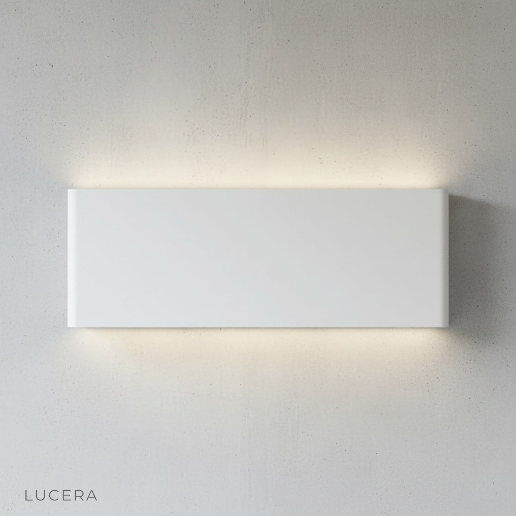 Cadmium wall lamp glowing at dusk on outdoor patio with IP65 waterproofing
