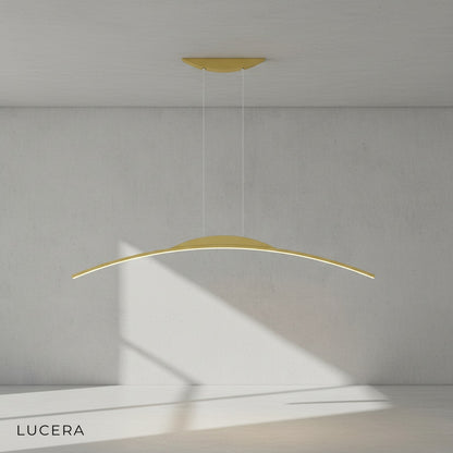 Edda chandelier hanging low over a bedside table in a stylish hotel room
