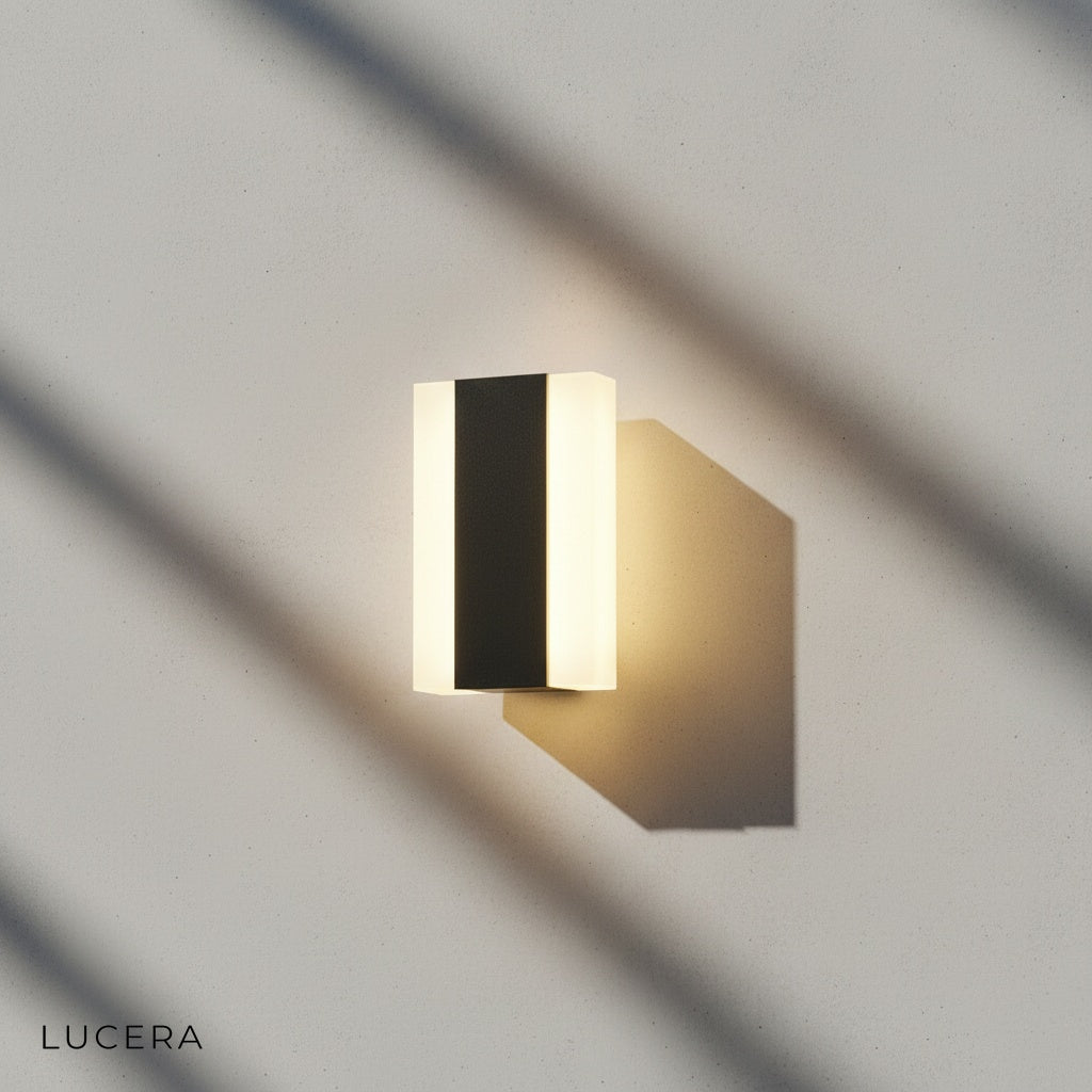 lamp mounted on dark charcoal siding with soft ambient light pool