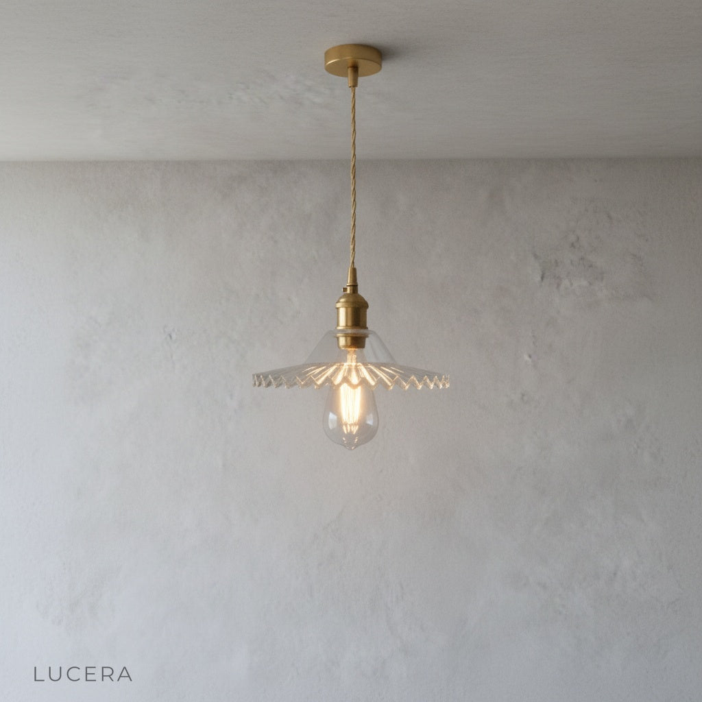 nighttime ambient shot of brass pendant light casting warm glow in dark living room corner