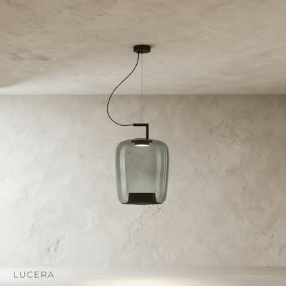 Yardang pendant light with soft ambient glow in bedroom corner beside upholstered bench