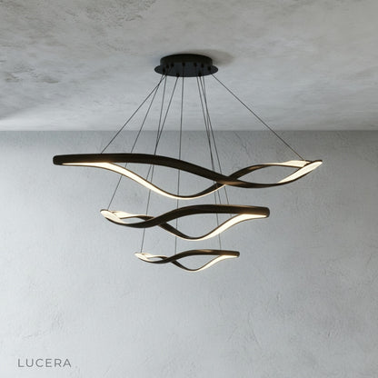 Lucera Deacon ring chandelier in a dining room with modern furniture, daytime