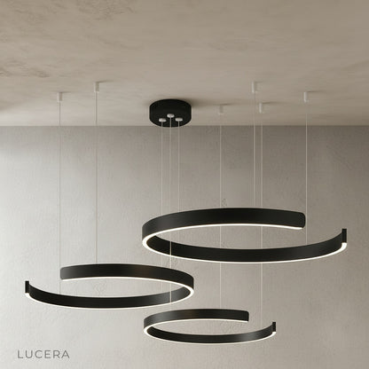 nighttime lifestyle shot of ring chandelier casting warm light in bedroom