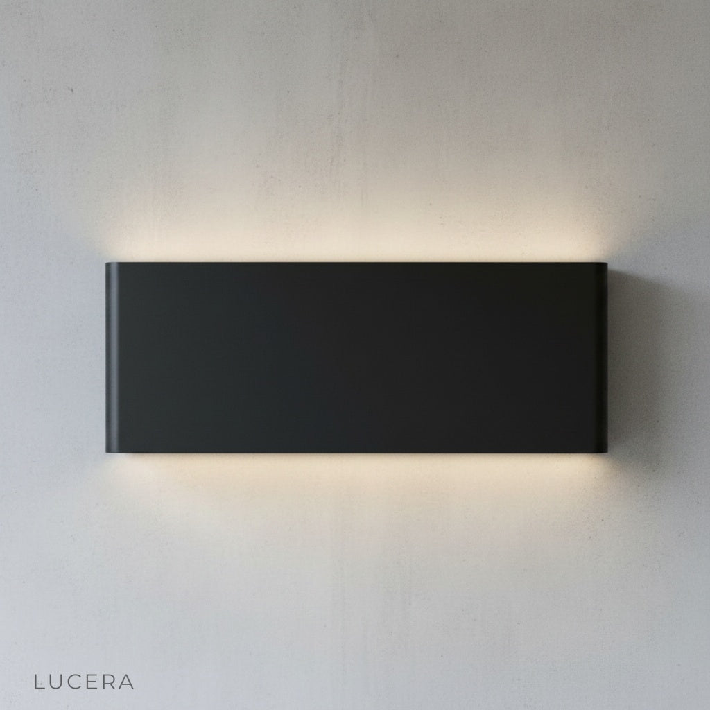 Lucera Cadmium wall lamp in bedroom reading nook casting inviting glow