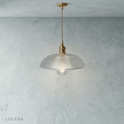 Harmony Pendant Light hanging low over bedside table in cozy reading nook with books