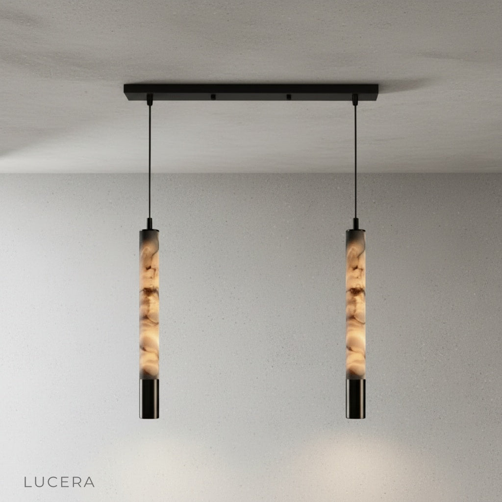 Yseult pendant light at night in a dining room with dimmed ambient light and glowing stone shade