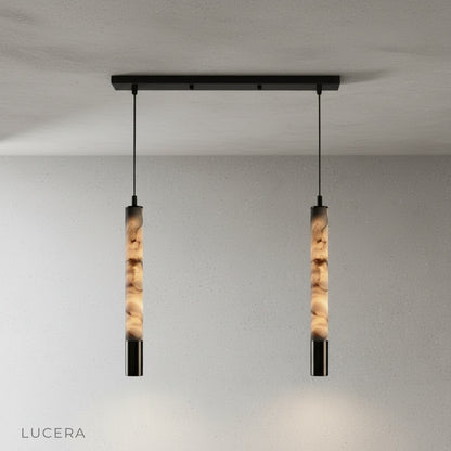Yseult pendant light at night in a dining room with dimmed ambient light and glowing stone shade