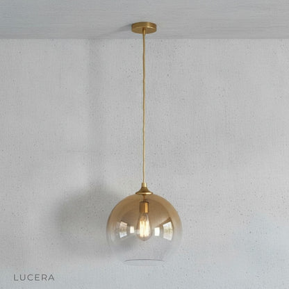 Overhead angle of green gold pendant light showing spherical shape and metallic gradient